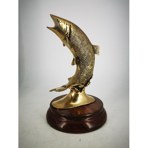 181 - A BRASS ORNAMENT IN THE FORM OF A LEAPING SALMON, mounted on a wooden base, 22cm tall approx.