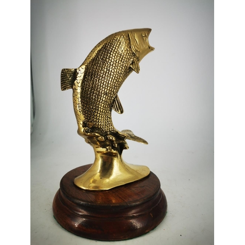 181 - A BRASS ORNAMENT IN THE FORM OF A LEAPING SALMON, mounted on a wooden base, 22cm tall approx.