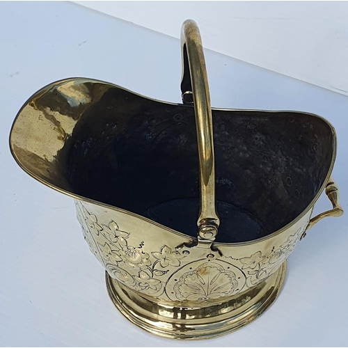 183 - A GOOD 19TH CENTURY POLISHED BRASS HELMET SHAPED COAL / LOG BUCKET, with swing handle to the top and... 