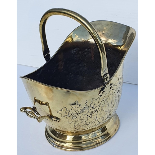 183 - A GOOD 19TH CENTURY POLISHED BRASS HELMET SHAPED COAL / LOG BUCKET, with swing handle to the top and... 