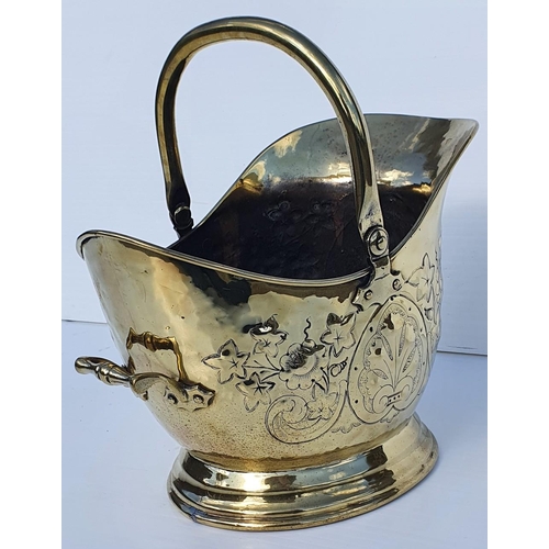 183 - A GOOD 19TH CENTURY POLISHED BRASS HELMET SHAPED COAL / LOG BUCKET, with swing handle to the top and... 