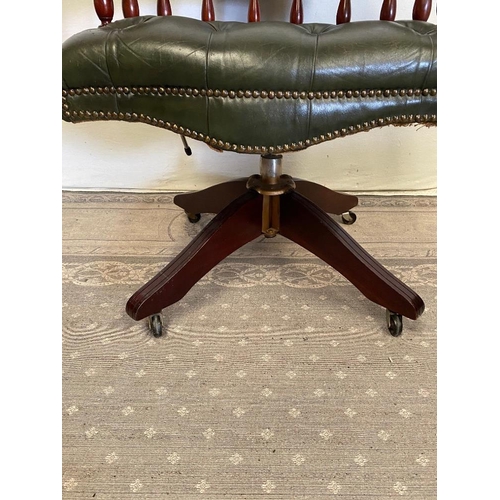 184 - A GREEN LEATHER BUTTON BACKED CAPTAINS CHAIR / DESK CHAIR, with swivel stand, and brass beaded detai... 