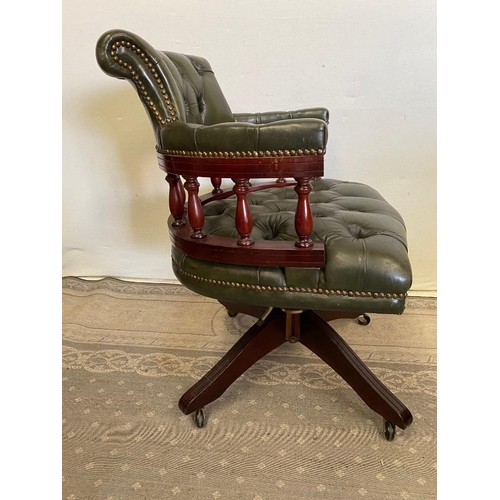 184 - A GREEN LEATHER BUTTON BACKED CAPTAINS CHAIR / DESK CHAIR, with swivel stand, and brass beaded detai... 