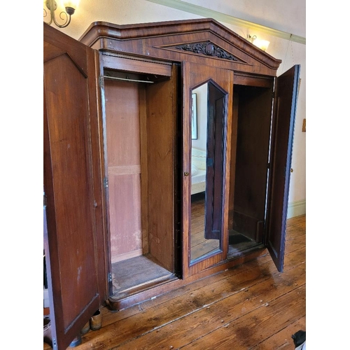 201 - A LATE 19TH CENTURY THREE DOOR MAHOGANY GENTLEMAN’S WARDROBE, with mirror, panelled doors and engrav... 