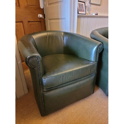 207 - A PAIR OF GREEN LEATHER CLUB CHAIRS / TUB SHAPED, with beaded trim, on castors, 78cm wide x 73cm hig... 