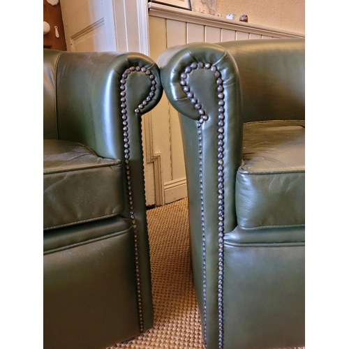 207 - A PAIR OF GREEN LEATHER CLUB CHAIRS / TUB SHAPED, with beaded trim, on castors, 78cm wide x 73cm hig... 