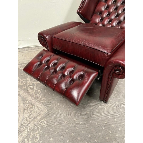 215 - A GOOD QUALITY OX BLOOD LEATHER WING BACK RECLINER ARMCHAIR, with deep buttoned back, and rope detai... 