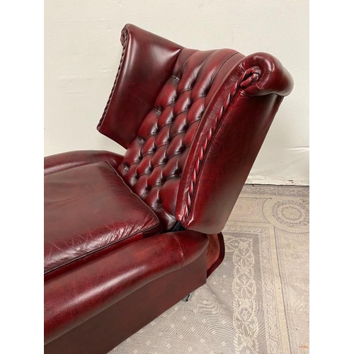 215 - A GOOD QUALITY OX BLOOD LEATHER WING BACK RECLINER ARMCHAIR, with deep buttoned back, and rope detai... 