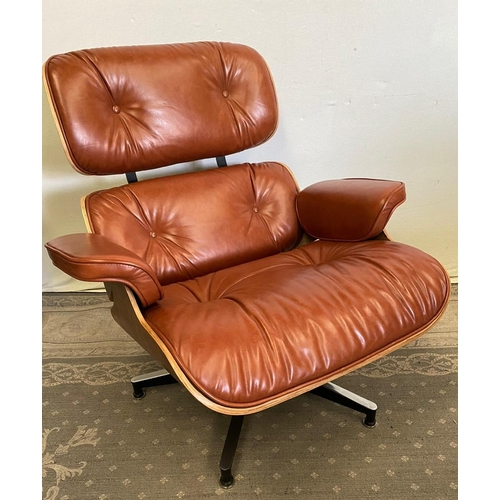 216 - A TAN LEATHER RECLINER CHAIR IN THE EAMES STYLE, with matching foot stool