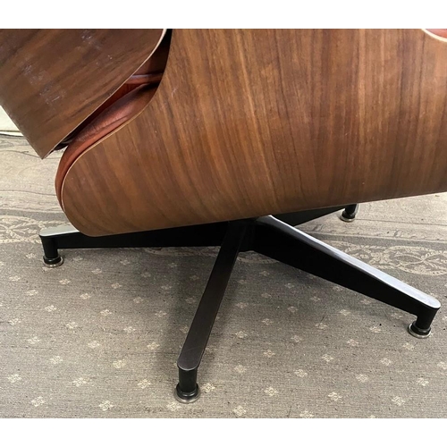 216 - A TAN LEATHER RECLINER CHAIR IN THE EAMES STYLE, with matching foot stool