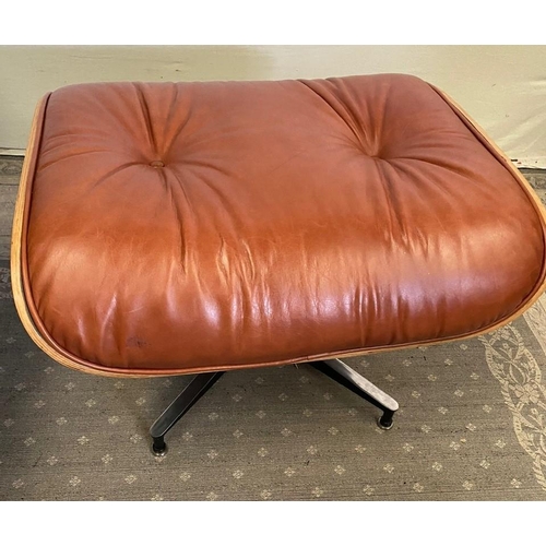 216 - A TAN LEATHER RECLINER CHAIR IN THE EAMES STYLE, with matching foot stool