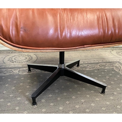 216 - A TAN LEATHER RECLINER CHAIR IN THE EAMES STYLE, with matching foot stool