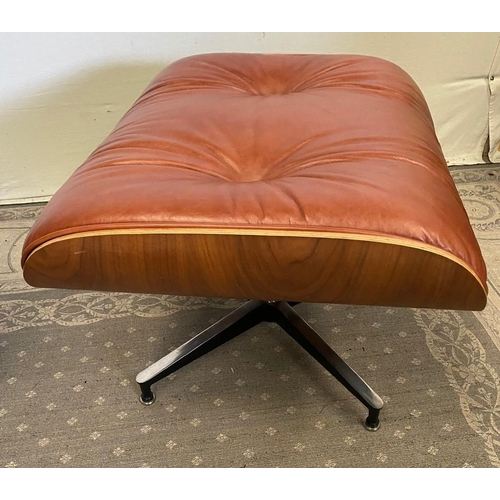 216 - A TAN LEATHER RECLINER CHAIR IN THE EAMES STYLE, with matching foot stool