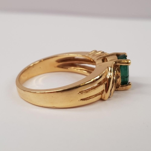 217 - A 14CT YELLOW GOLD EMERALD AND DIAMOND RING, with oval central emerald stone, with diamond accented ... 