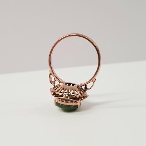 219 - AN 18CT ROSE GOLD JADE RING, with rope and leaf detail to the raised setting and shoulders, ring siz... 