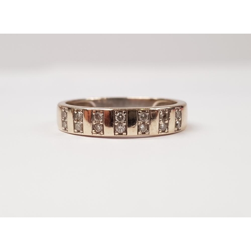 220 - A 14CT GOLD AND DIAMOND BAND, with 7 pairs of stacked diamonds