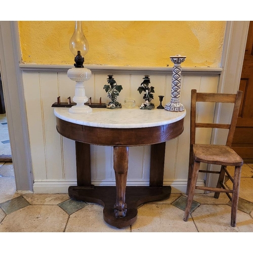 223 - A 19TH CENTURY MAHOGANY MARBLE TOPPED DEMI LUNE CONSOLE TABLE, with carved centre leg and flat back ... 