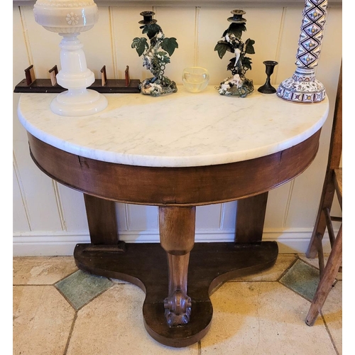 223 - A 19TH CENTURY MAHOGANY MARBLE TOPPED DEMI LUNE CONSOLE TABLE, with carved centre leg and flat back ... 