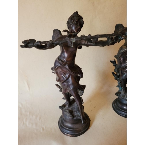 226 - A PAIR OF BRONZED FIGURES IN THE FORM OF WINGED SPRITES, holding a branch aloft.