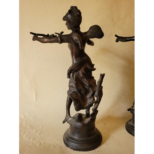 226 - A PAIR OF BRONZED FIGURES IN THE FORM OF WINGED SPRITES, holding a branch aloft.