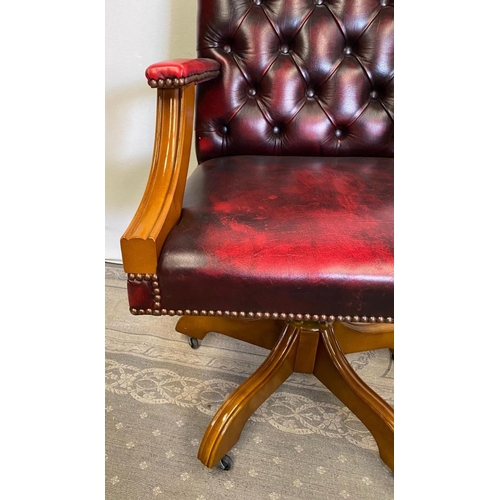 235 - A RED LEATHER OFFICE / DESK CHAIR, with walnut frame, swivels on base, 99cm tall to the back, 62cm x... 