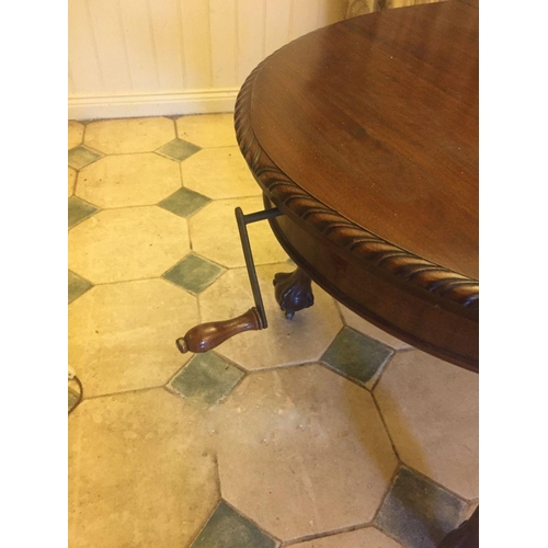 239 - A MAHOGANY OVAL DINING TABLE, extendable, on cabriole leg, claw and ball feet, castor wheels, two le... 