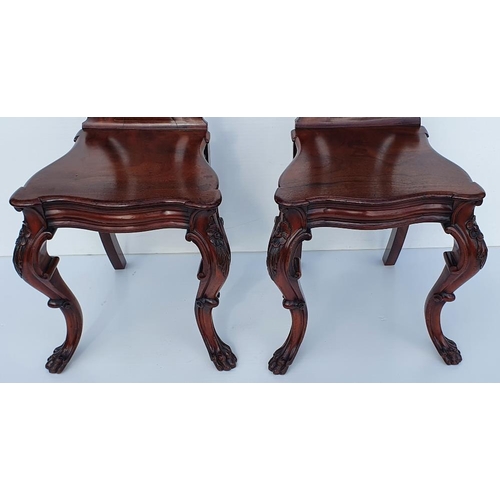 33 - A VERY FINE PAIR OF 19TH CENTURY IRISH MAHOGANY HALL CHAIRS, each with a carved back support with sc... 