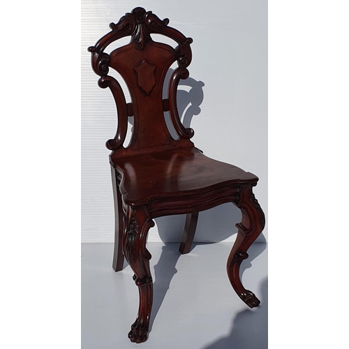 33 - A VERY FINE PAIR OF 19TH CENTURY IRISH MAHOGANY HALL CHAIRS, each with a carved back support with sc... 