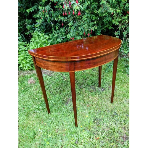 34 - A VERY FINE GEORGIAN MAHOGANY FOLD OVER TEA TABLE, circa 1800, with D shaped top having satinwood st... 