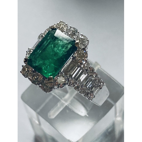 4 - A STUNNING 18CT WHITE GOLD COLUMBIAN EMERALD AND DIAMOND CLUSTER RING, the central emerald weighs 2.... 