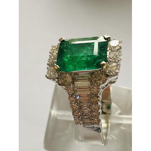 4 - A STUNNING 18CT WHITE GOLD COLUMBIAN EMERALD AND DIAMOND CLUSTER RING, the central emerald weighs 2.... 