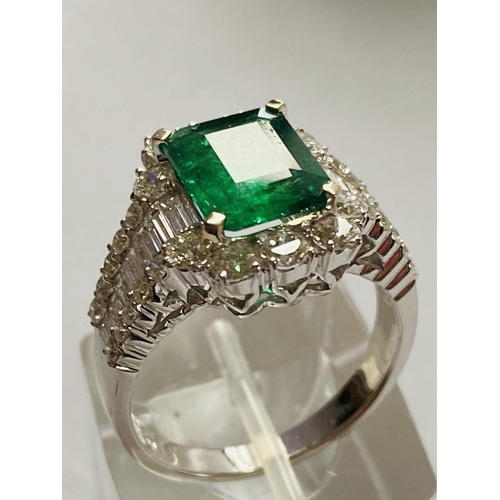 4 - A STUNNING 18CT WHITE GOLD COLUMBIAN EMERALD AND DIAMOND CLUSTER RING, the central emerald weighs 2.... 