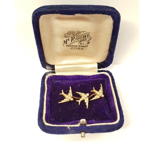 57 - A LOVELY YELLOW GOLD ANTIQUE SEED PEARL SWALLOW BROOCH, with three swallows in flight