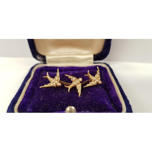 57 - A LOVELY YELLOW GOLD ANTIQUE SEED PEARL SWALLOW BROOCH, with three swallows in flight