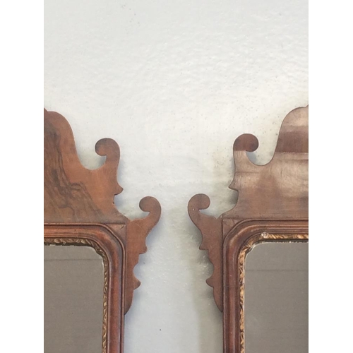 68 - A PAIR OF 19TH CENTURY CHIPPENDALE STYLE WALL MIRRORS, with scrolling detail to the shaped frame, th... 