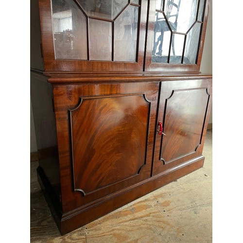 72 - A GOOD QUALITY MAHOGANY GLAZED BOOKCASE, with broken temple pediment, over a pair of astragal glazed... 