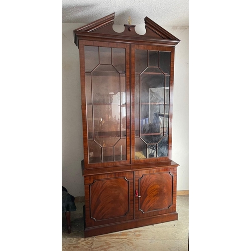 72 - A GOOD QUALITY MAHOGANY GLAZED BOOKCASE, with broken temple pediment, over a pair of astragal glazed... 