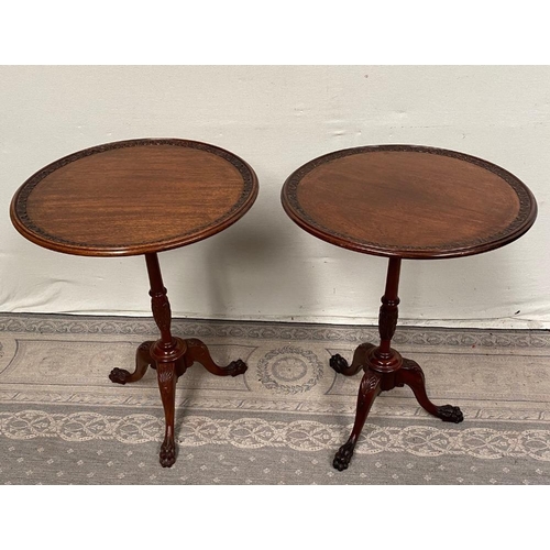 76 - A PAIR OF IRISH MAHOGANY WINE TABLES / LAMP TABES, each with foliage decorated rim, raised on turned... 