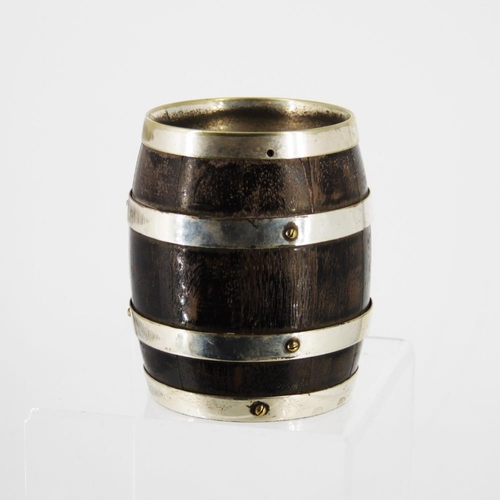 86 - A LATE 19TH CENTURY COOPERED WOODEN MUG, in the form of a barrel, with silver plated bands and handl... 