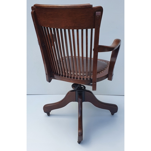 78 - A GOOD QUALITY EDWARDIAN OAK SWIVEL & TILT OFFICE CHAIR, by Ford & Johnson, Chicago.