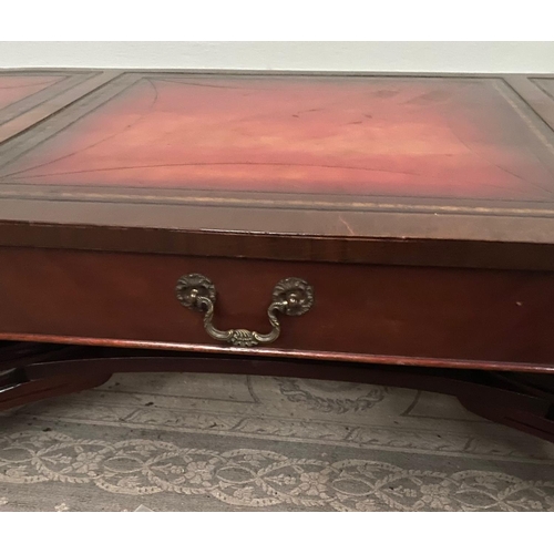 104 - A LOW RISE MAHOGANY LEATHER TOPPED COFFEE TABLE, with a pair of drawers to the front, the leather to... 