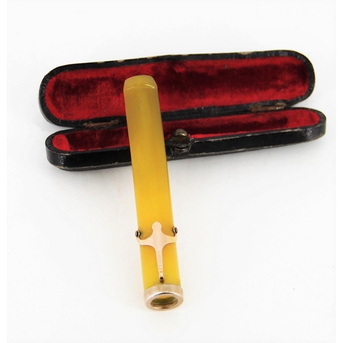 115 - A CASED YELLOW AMBER CIGARETTE HOLDER with gold clip and base, presented in the original case with v... 