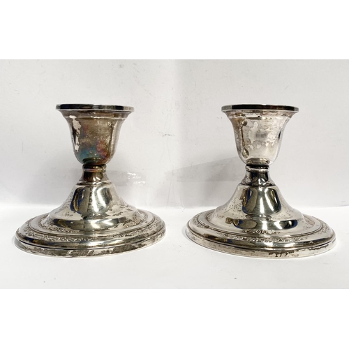 119 - A PAIR OF STERLING SILVER CANDLESTICKS, weighted, with floral decoration to base. Marked ‘Courtship ... 