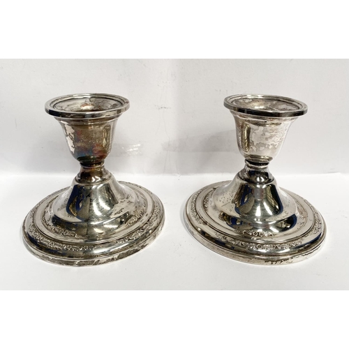 119 - A PAIR OF STERLING SILVER CANDLESTICKS, weighted, with floral decoration to base. Marked ‘Courtship ... 