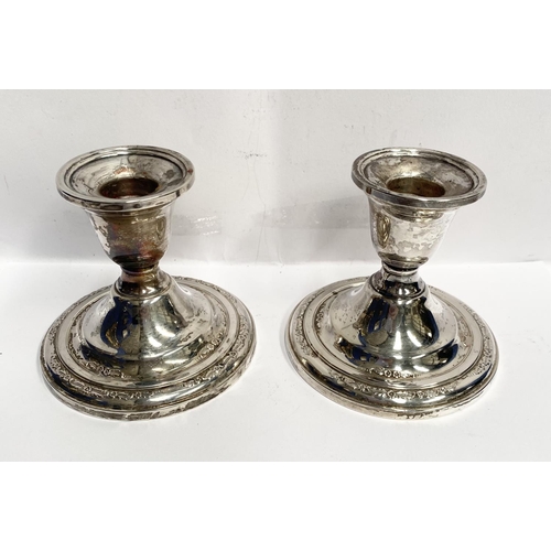 119 - A PAIR OF STERLING SILVER CANDLESTICKS, weighted, with floral decoration to base. Marked ‘Courtship ... 