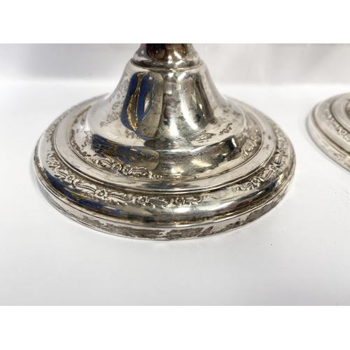 119 - A PAIR OF STERLING SILVER CANDLESTICKS, weighted, with floral decoration to base. Marked ‘Courtship ... 