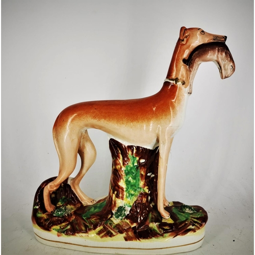 127 - A 19TH CENTURY STAFFORDSHIRE FIGURE OF A GREYHOUND HOLDING A HARE, a fine piece of mid/late 19th cen... 