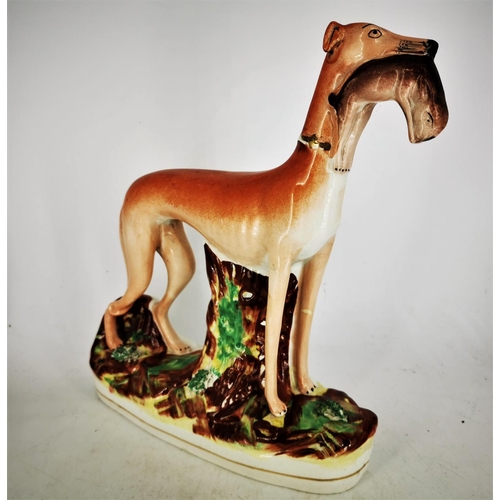 127 - A 19TH CENTURY STAFFORDSHIRE FIGURE OF A GREYHOUND HOLDING A HARE, a fine piece of mid/late 19th cen... 