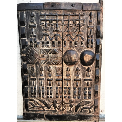 129 - A 19TH CENTURY DOGON GRANARY DOOR, Dogon doors are intricately carved wood panel doors that originat... 