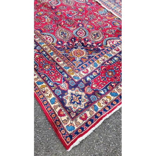 145 - A VERY FINE PERSIAN MASHAD FLOOR RUG, with brightly coloured red main ground, with indigo, pale blue... 